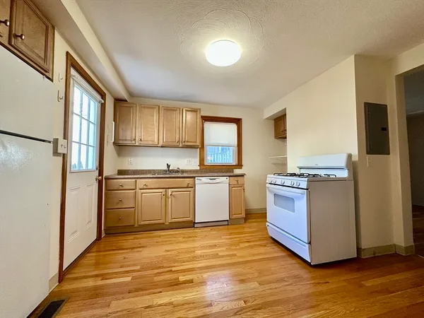 a kitchen with stainless steel appliances granite countertop a refrigerator and a stove top oven