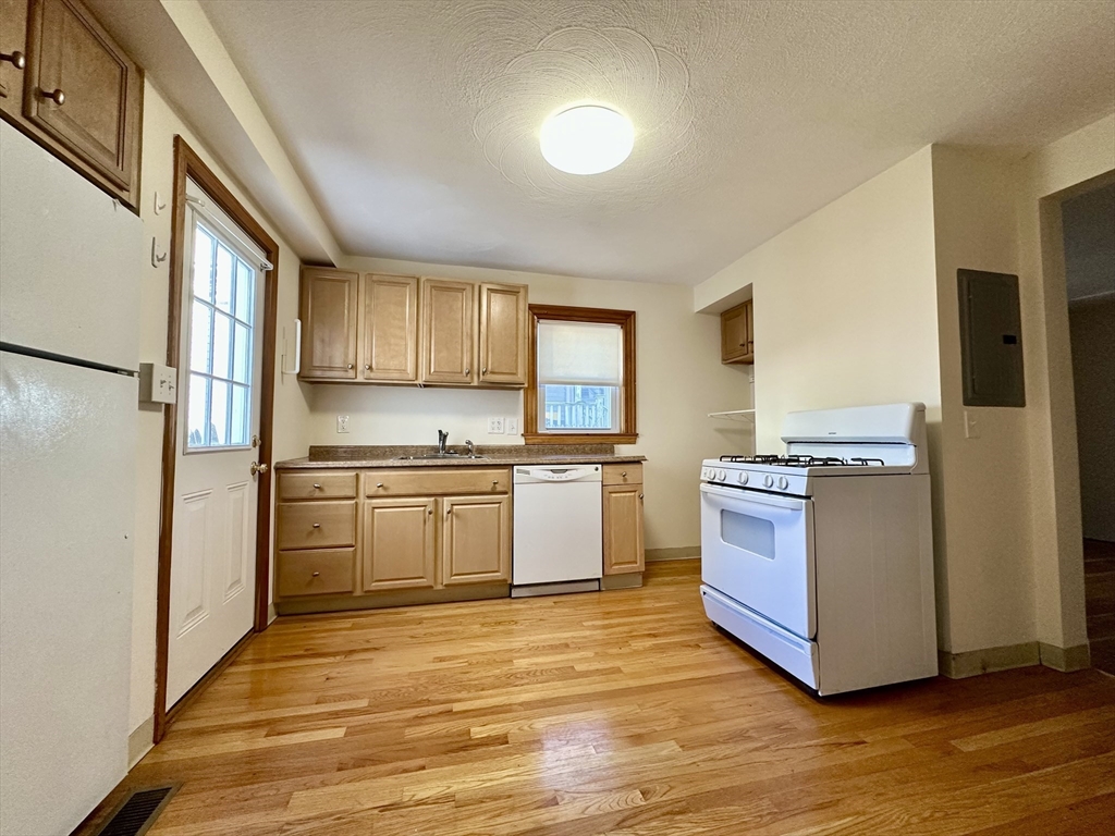 a kitchen with stainless steel appliances granite countertop a refrigerator and a stove top oven