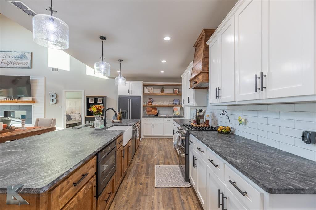 684 Taylor Ridge Estates Road Abilene, TX 79603 - Photo 11 of 39 a kitchen with sink stove and cabinets