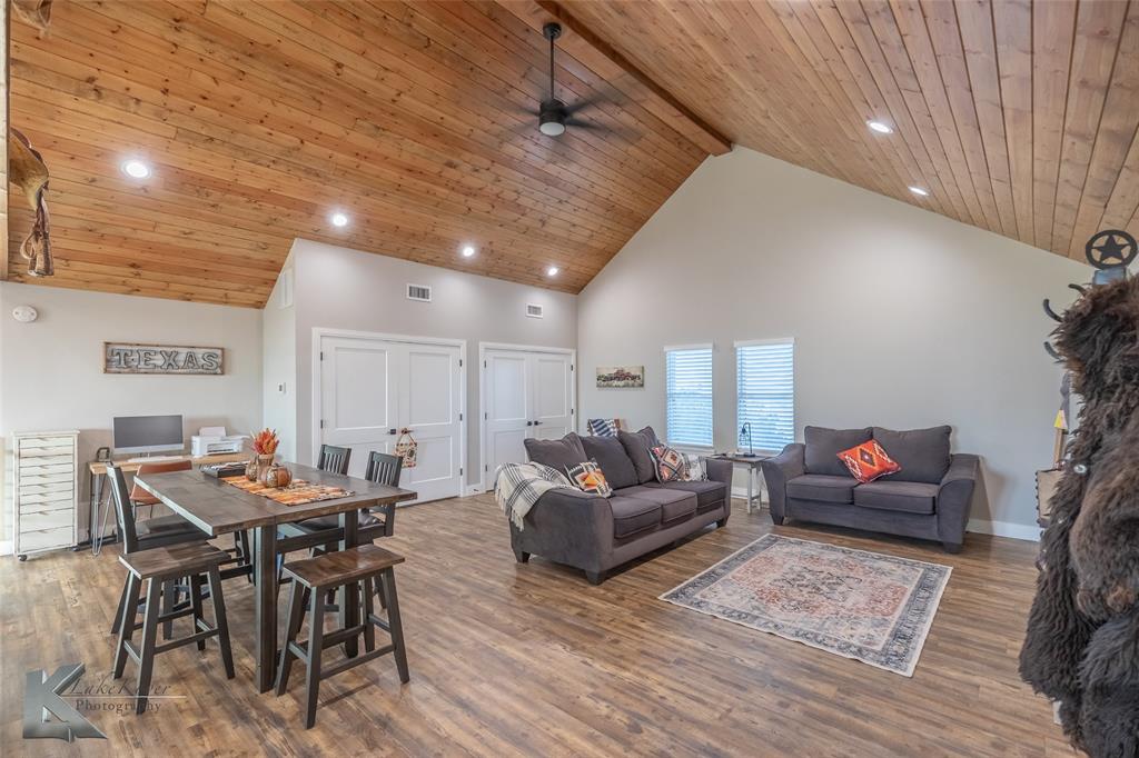 684 Taylor Ridge Estates Road Abilene, TX 79603 - Photo 14 of 39 a living room with furniture and a dining table with wooden floor