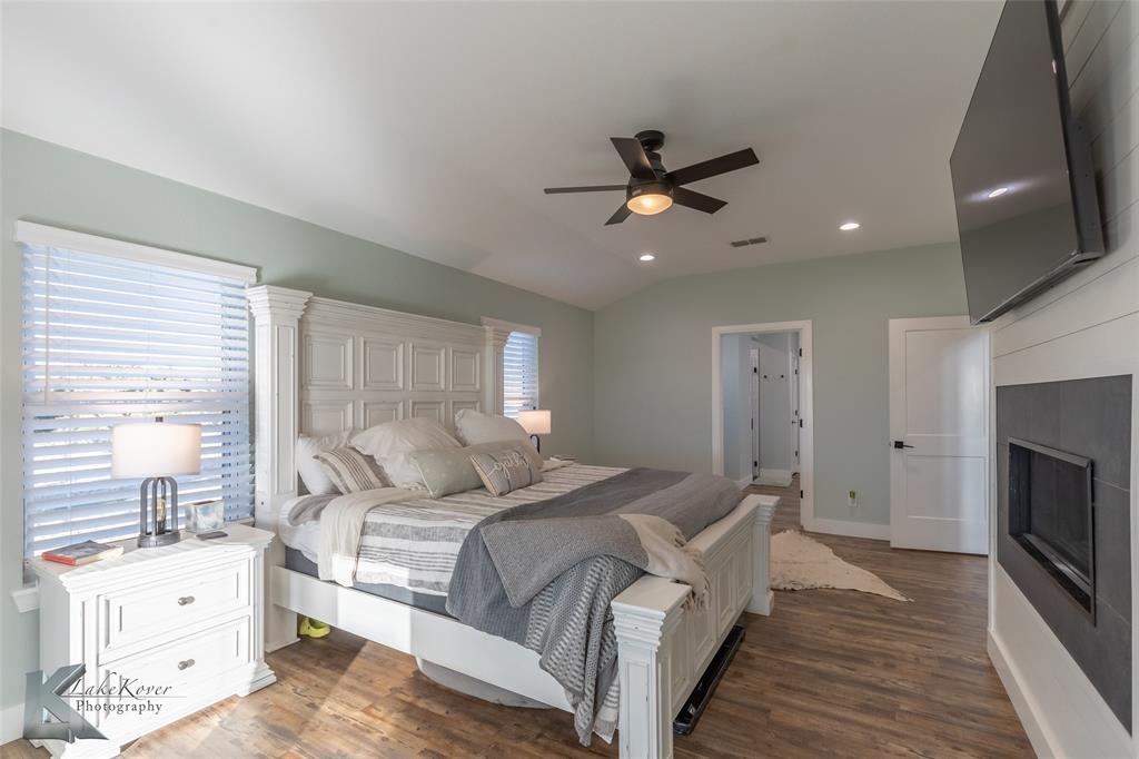 684 Taylor Ridge Estates Road Abilene, TX 79603 - Photo 16 of 39 a bedroom with a bed and a chandelier