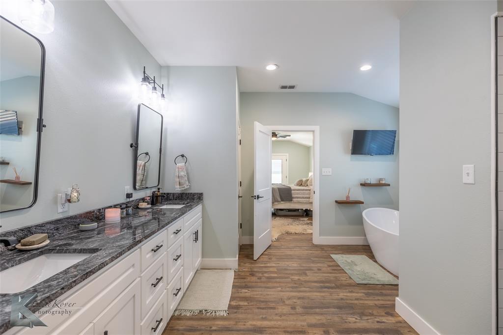 684 Taylor Ridge Estates Road Abilene, TX 79603 - Photo 18 of 39 a spacious bathroom with a double vanity sink and a mirror