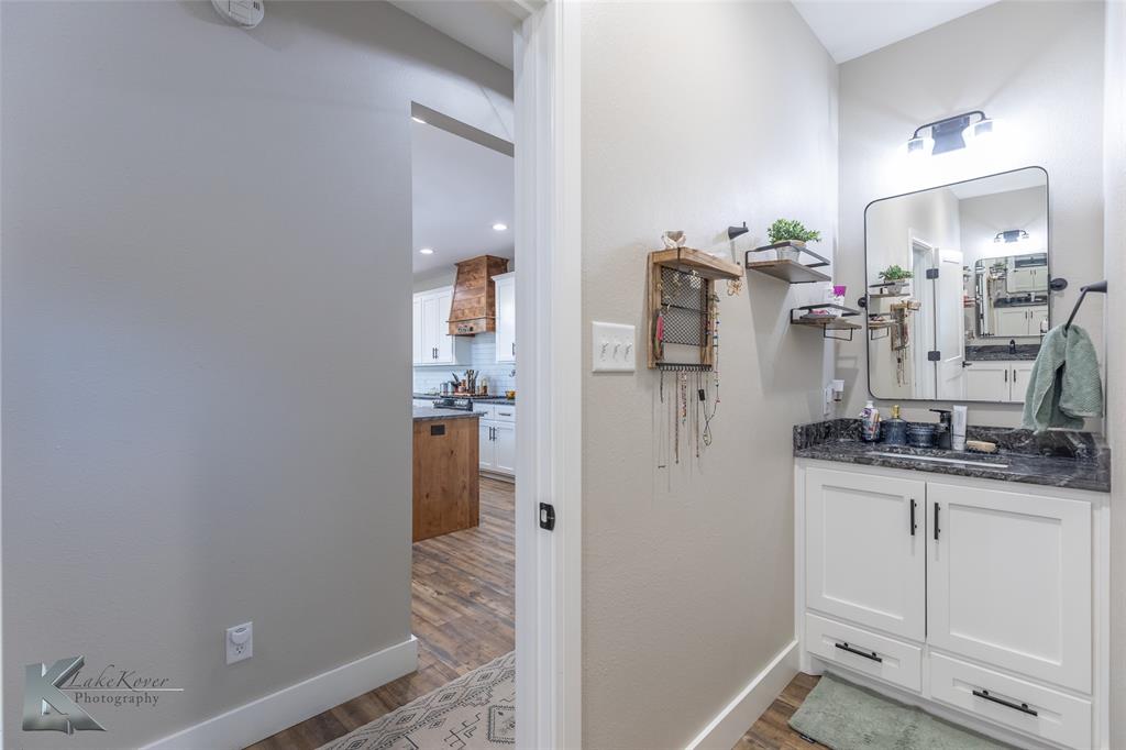 684 Taylor Ridge Estates Road Abilene, TX 79603 - Photo 22 of 39 a room with a sink and a mirror