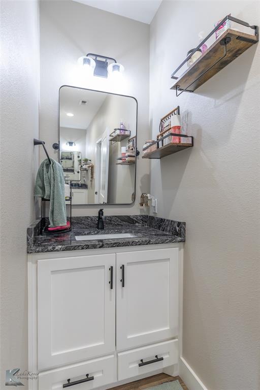 684 Taylor Ridge Estates Road Abilene, TX 79603 - Photo 23 of 39 a bathroom with a granite countertop sink and a mirror