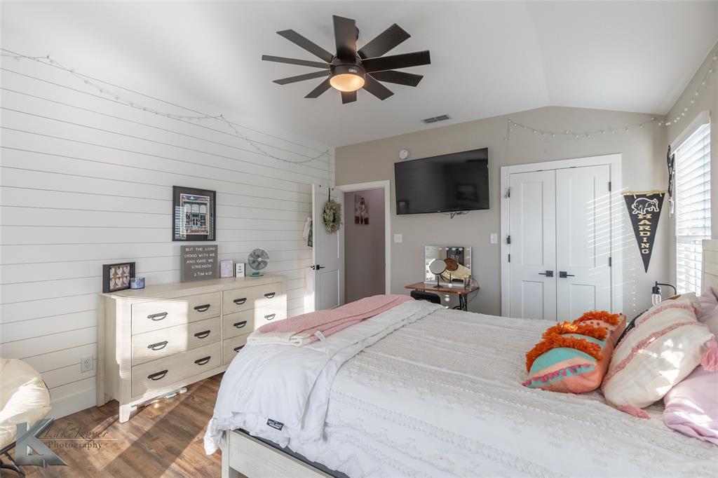 684 Taylor Ridge Estates Road Abilene, TX 79603 - Photo 26 of 39 a bedroom with a bed and a flat screen tv