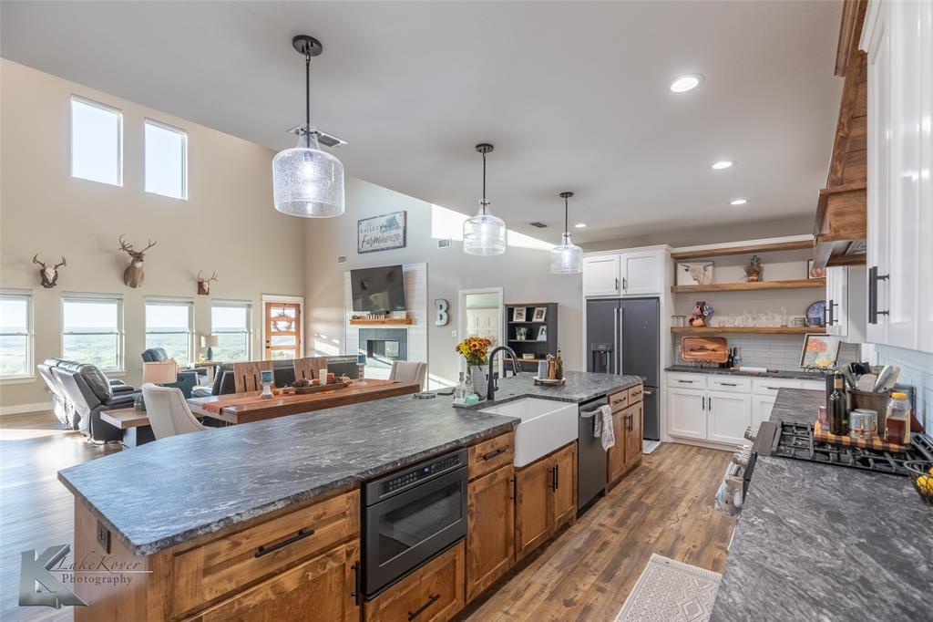 684 Taylor Ridge Estates Road Abilene, TX 79603 - Photo 10 of 39 a large kitchen with lots of counter space and wooden floor