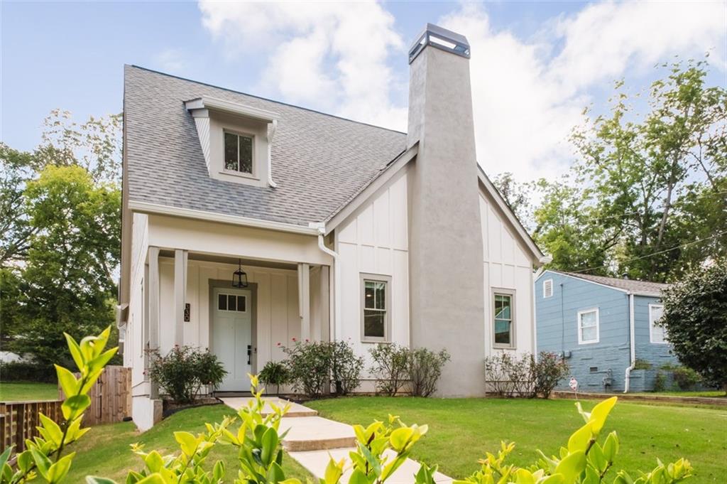 a front view of house with yard outdoor seating and barbeque oven