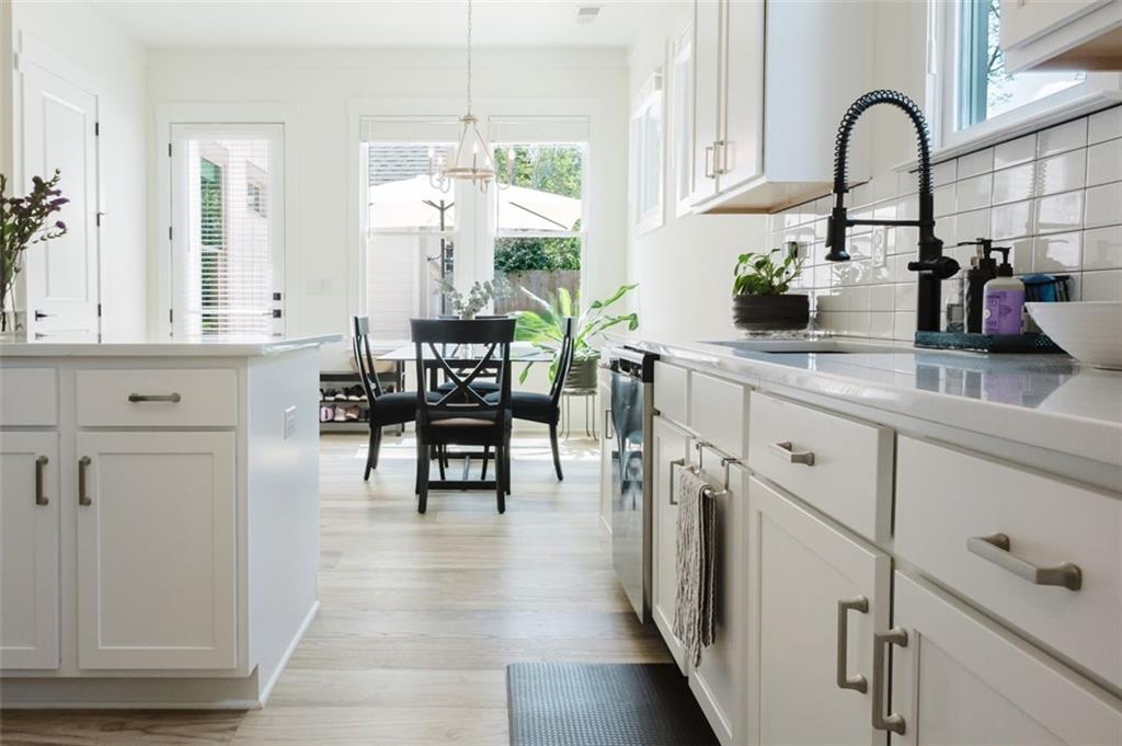 330 Mount Zion Road Southwest Hapeville, GA 30354 - Photo 13 of 41 a kitchen with stainless steel appliances white cabinets and wooden floor