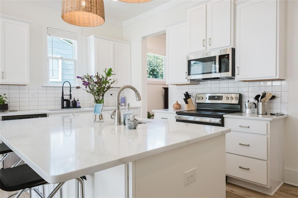 330 Mount Zion Road Southwest Hapeville, GA 30354 - Photo 14 of 41 a kitchen with stainless steel appliances a sink a stove and cabinets