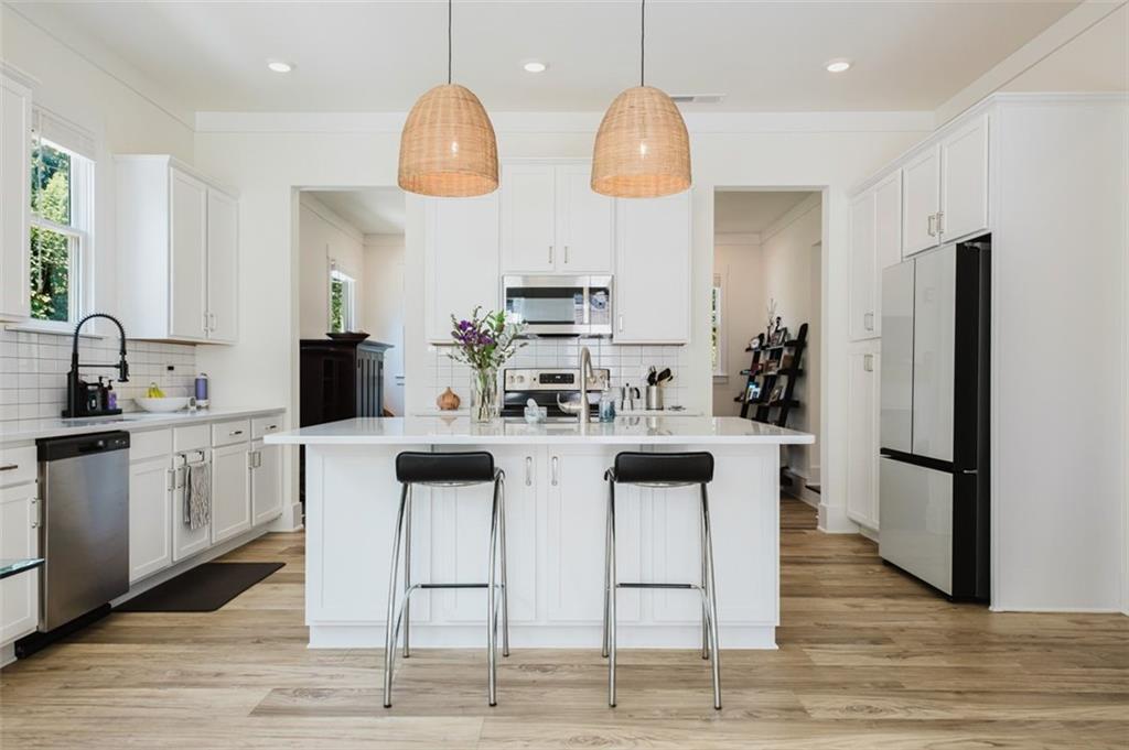 330 Mount Zion Road Southwest Hapeville, GA 30354 - Photo 2 of 41 a kitchen with stainless steel appliances kitchen island granite countertop a stove a sink and a refrigerator