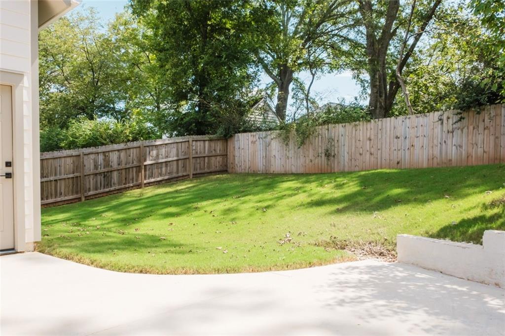 330 Mount Zion Road Southwest Hapeville, GA 30354 - Photo 37 of 41 a view of a backyard with a small cabin and wooden fence