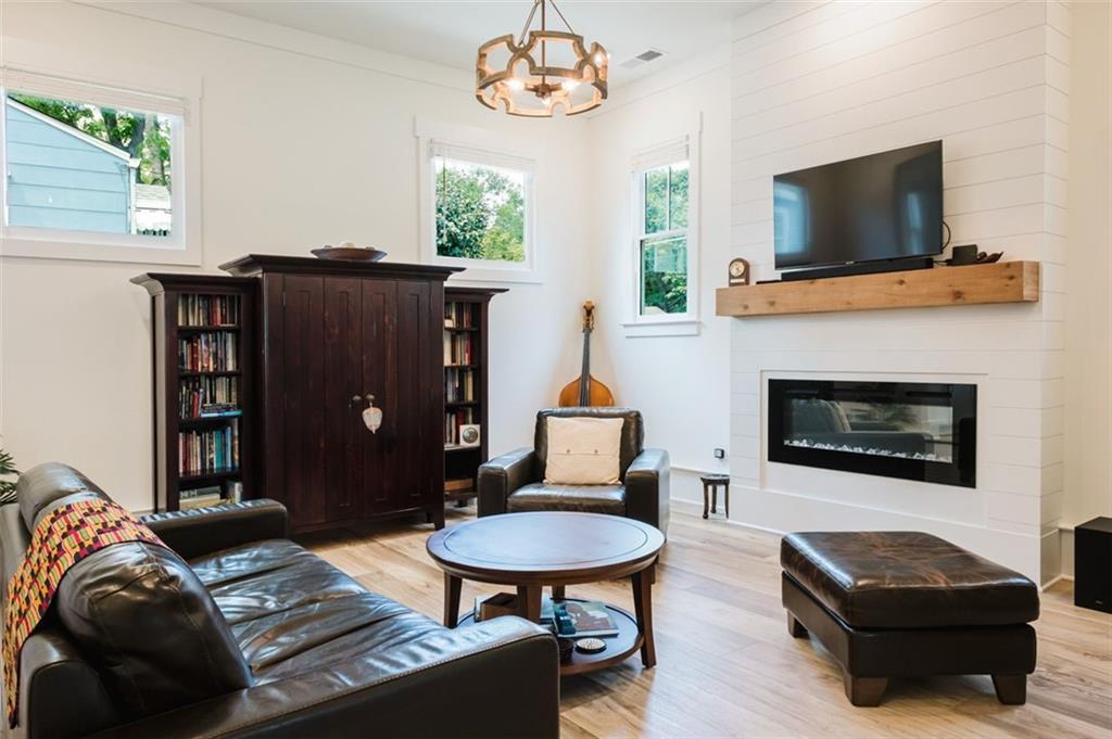 330 Mount Zion Road Southwest Hapeville, GA 30354 - Photo 9 of 41 a living room with furniture a flat screen tv and a fireplace