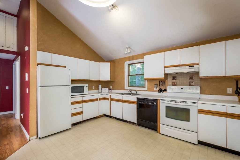 88 Fiskdale Road Brookfield, MA 01506 - Photo 4 of 30 a kitchen with white cabinets and white appliances
