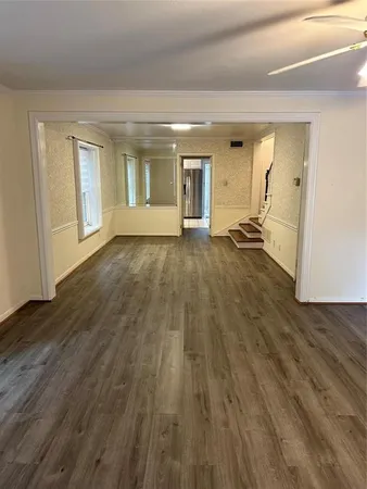 a view of a room with wooden floor and window