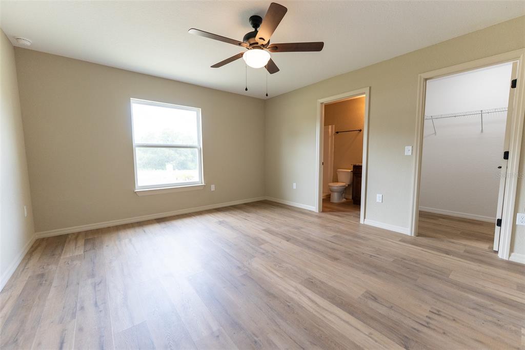 13060 Southwest 83rd Terrace Road Ocala, FL 34473 - Photo 9 of 42 an empty room with wooden floor and windows