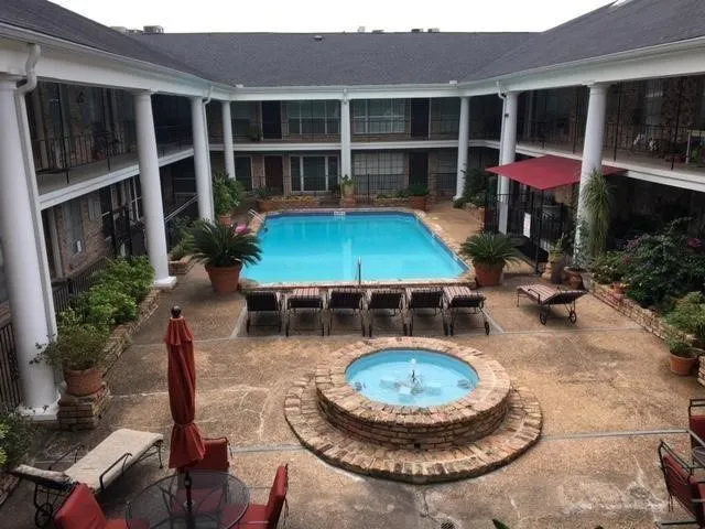 a view of a house with backyard sitting area and swimming pool