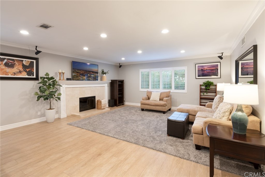 484 Traverse Drive Costa Mesa, CA 92626 - Photo 7 of 17 a living room with furniture a fireplace and a potted plant