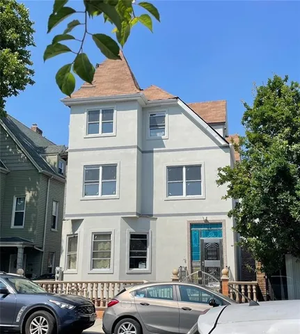 a front view of a building with parking space