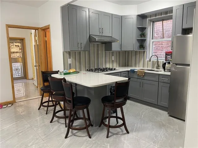 a kitchen with a sink cabinets and dining table