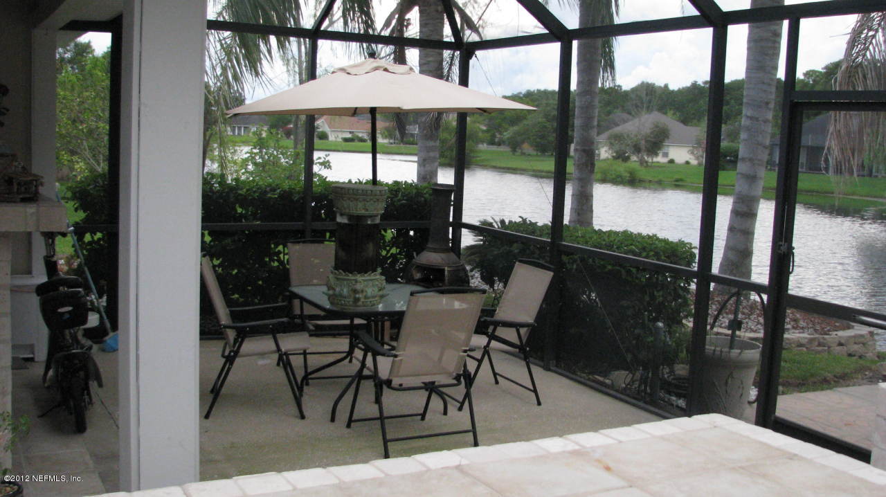 4152 East Ripken Jacksonville, FL 32224 - Photo 11 of 14 a table and chairs in front of a building