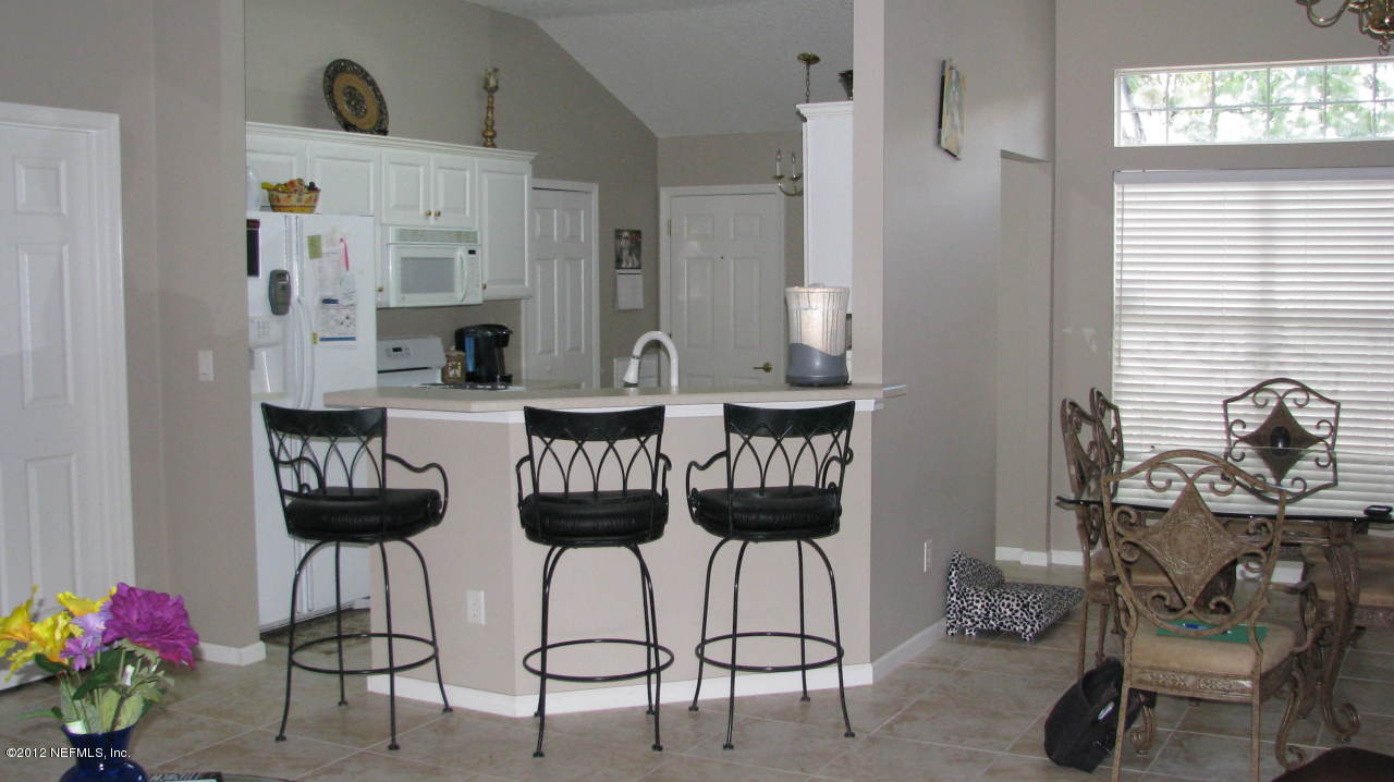 4152 East Ripken Jacksonville, FL 32224 - Photo 2 of 14 a view of dining room and kitchen with table and chairs