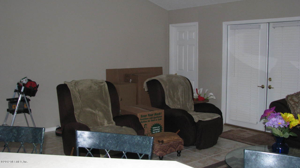4152 East Ripken Jacksonville, FL 32224 - Photo 5 of 14 a living room with furniture and flowers