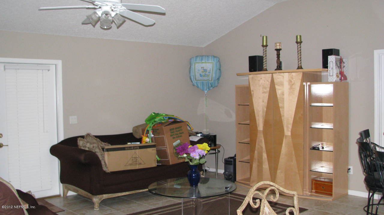 4152 East Ripken Jacksonville, FL 32224 - Photo 9 of 14 a living room with furniture and a chandelier