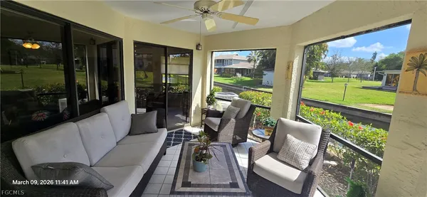a living room with couch and a floor to ceiling window