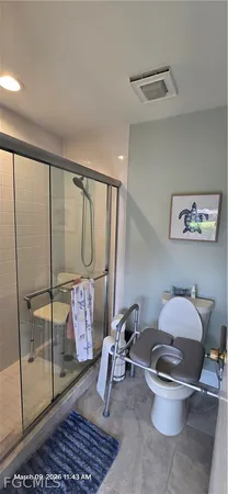 a bathroom with a glass shower door