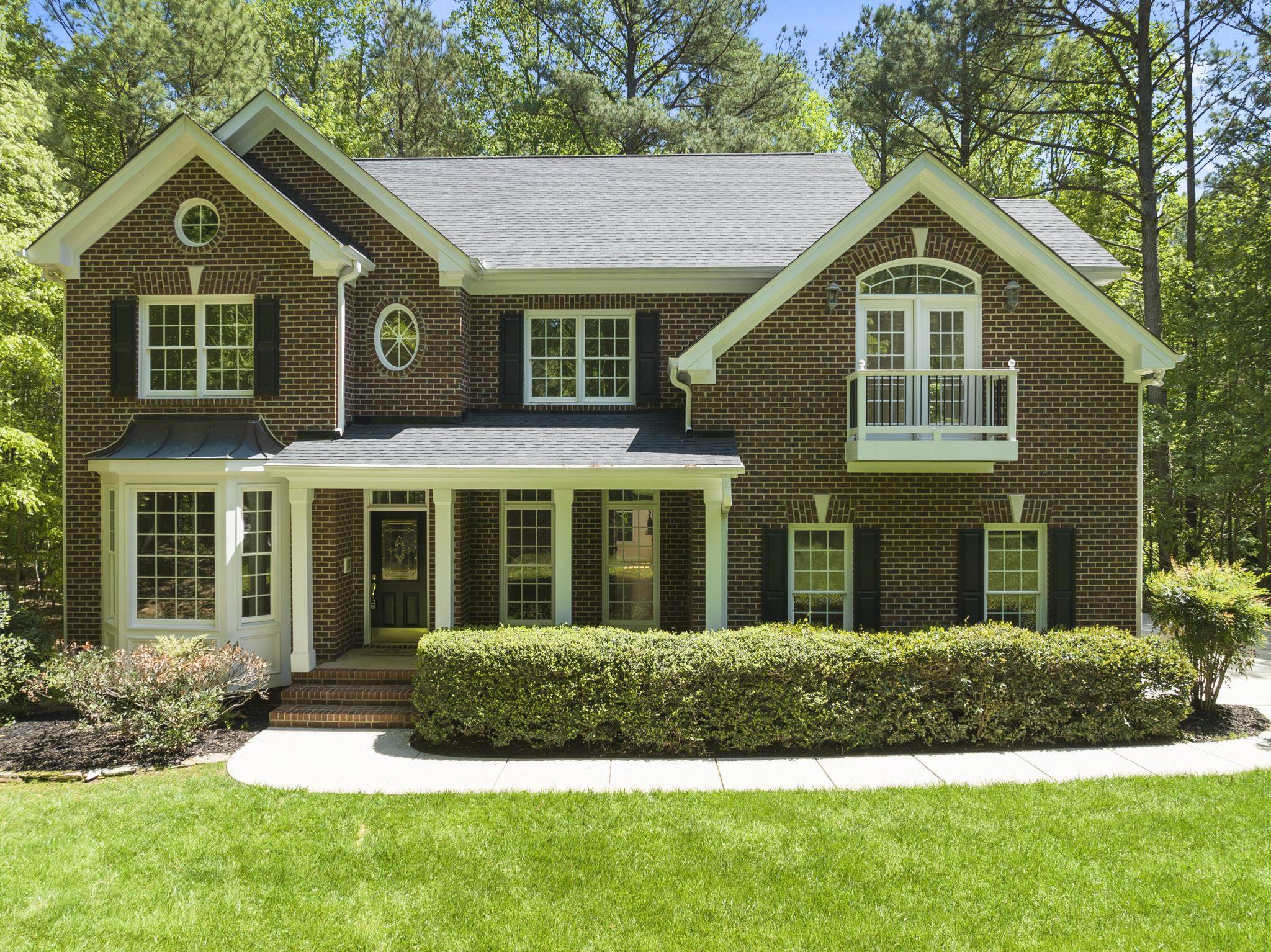 9436 Macon Road Raleigh, NC 27613 - Photo 1 of 37 a front view of a house with a yard