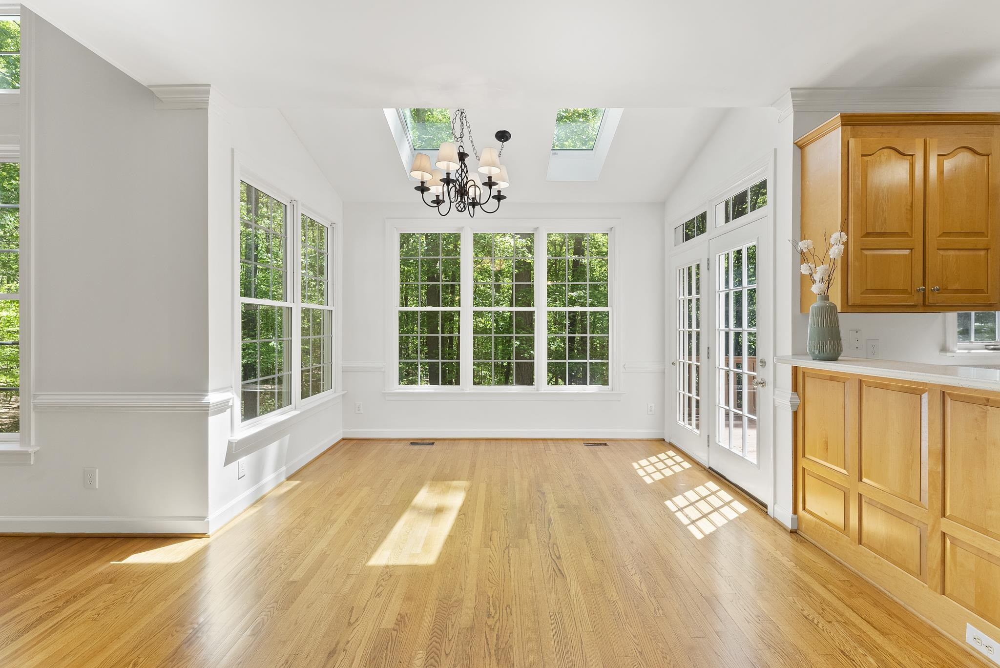 9436 Macon Road Raleigh, NC 27613 - Photo 18 of 37 a view of an empty room with window and wooden floor