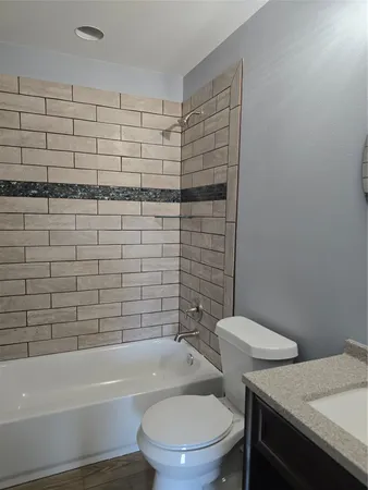 a bathroom with a toilet and a bathtub
