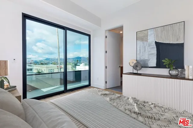 a bedroom with a large bed and a large window