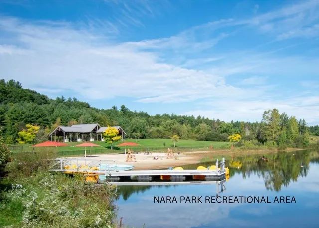 a view of a lake with houses in the back