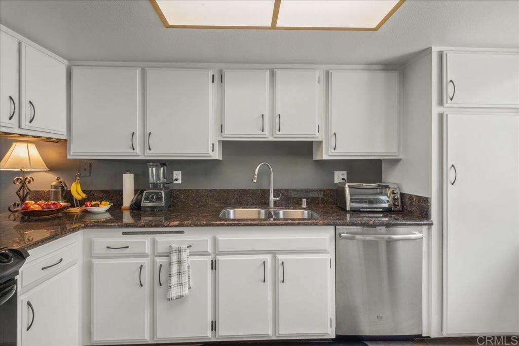 3047 Highlands Boulevard Spring Valley, CA 91977 - Photo 9 of 39 a kitchen with stainless steel appliances granite countertop a sink stove and white cabinets