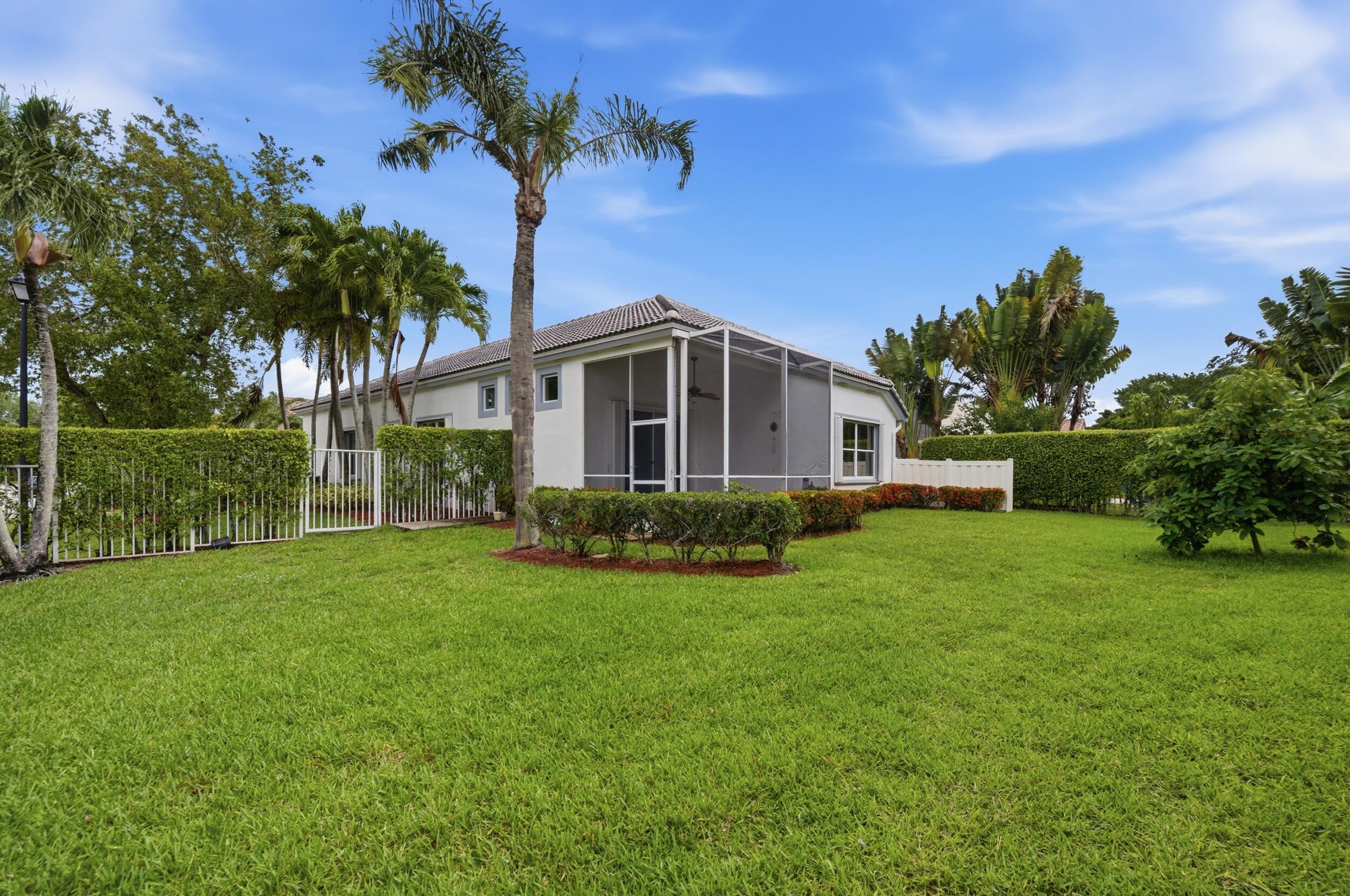 8534 Vía D Oro Boca Raton, FL 33433 - Photo 33 of 34 a front view of a house with garden