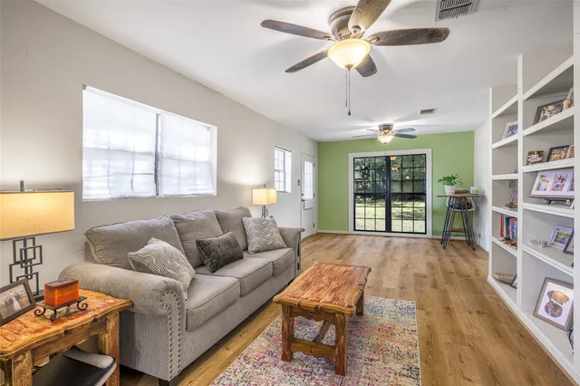 a living room with furniture and a book shelf