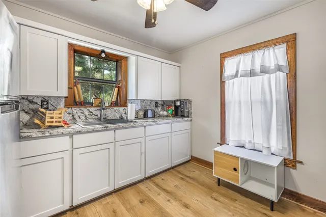 a bathroom with a sink and a window