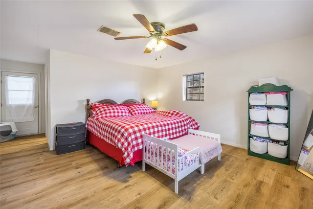 a bedroom with a bed and a window