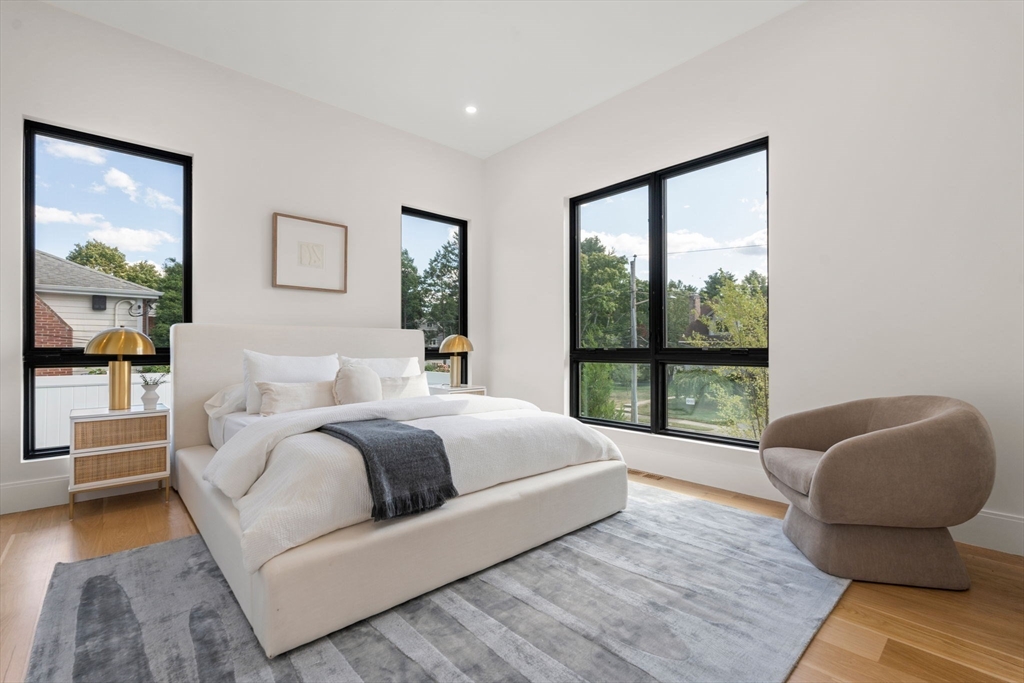 29 Levbert Road Newton, MA 02459 - Photo 16 of 40 a spacious bedroom with a bed and glass window