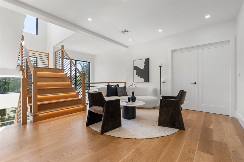 29 Levbert Road Newton, MA 02459 - Photo 19 of 40 a living room with furniture a wooden floor and a chandelier
