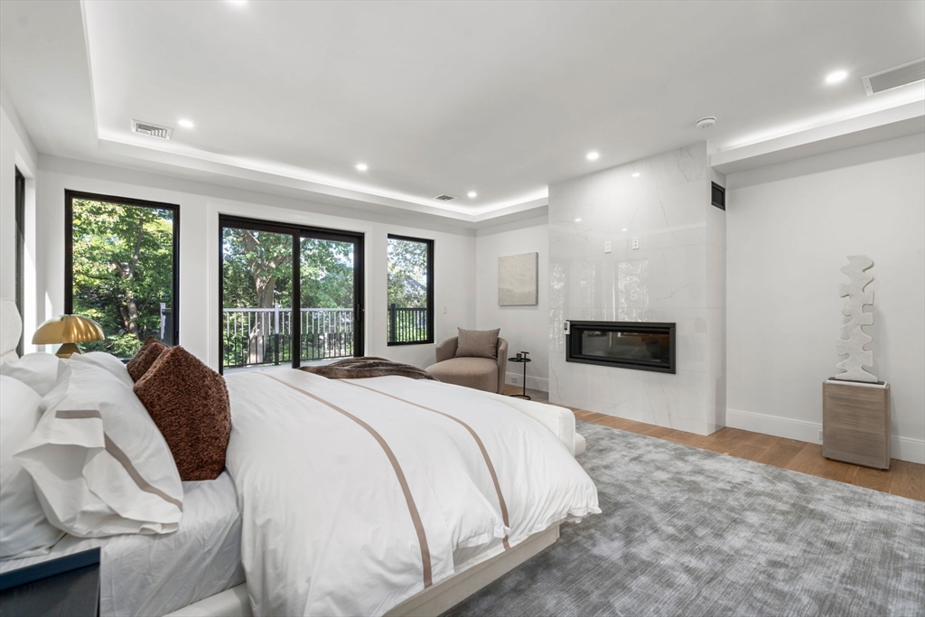 29 Levbert Road Newton, MA 02459 - Photo 21 of 40 a spacious bedroom with a bed and a fireplace