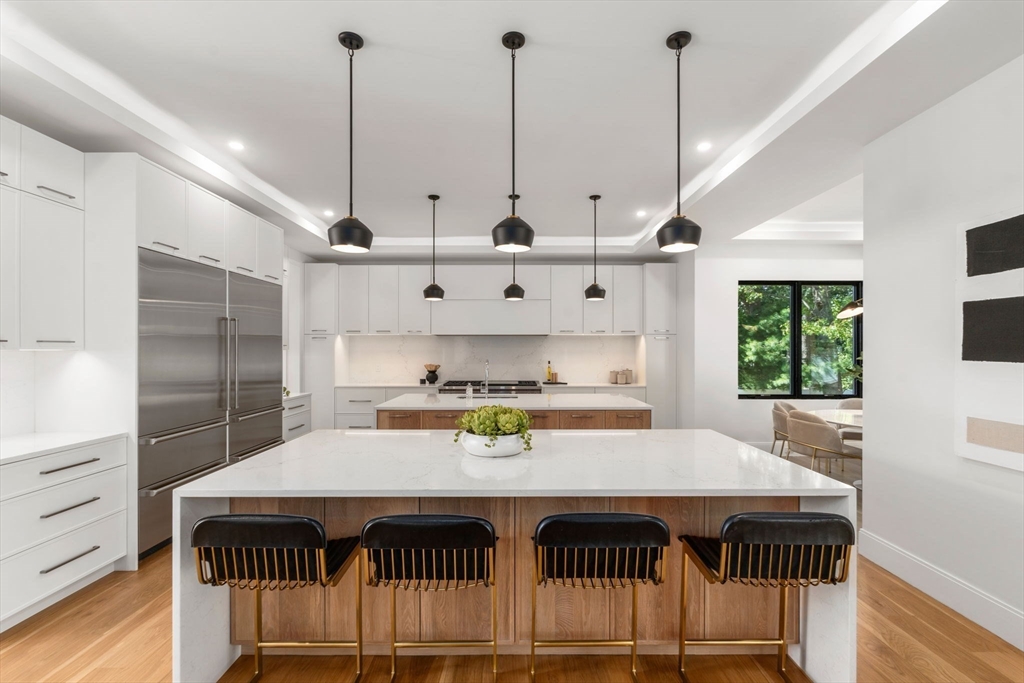 29 Levbert Road Newton, MA 02459 - Photo 5 of 40 a kitchen with kitchen island a stove a table and chairs in it