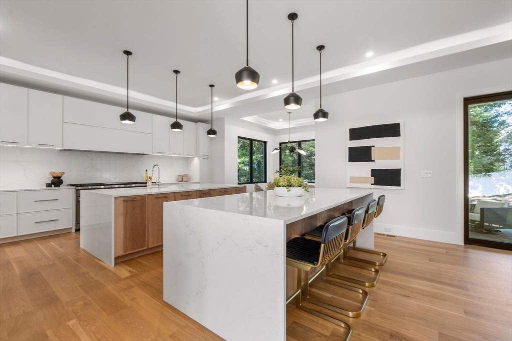 29 Levbert Road Newton, MA 02459 - Photo 6 of 40 a kitchen with kitchen island a stove a counter top space a sink and appliances