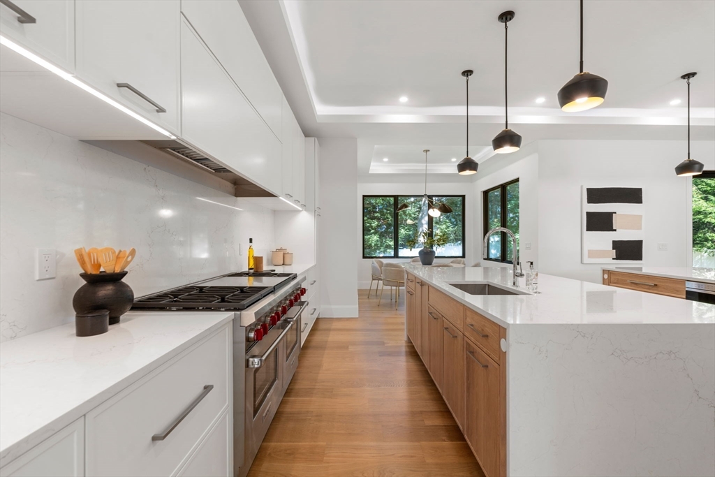 29 Levbert Road Newton, MA 02459 - Photo 7 of 40 a kitchen with stainless steel appliances granite countertop a sink and a wooden floors