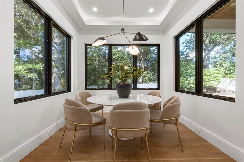 29 Levbert Road Newton, MA 02459 - Photo 9 of 40 a dining room with furniture a chandelier and wooden floor