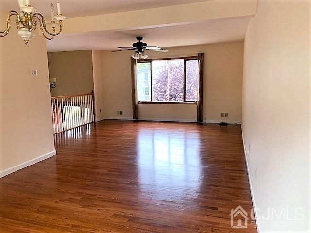 24 Hillsdale Road Edison, NJ 08820 - Photo 11 of 41 an empty room with wooden floor and windows