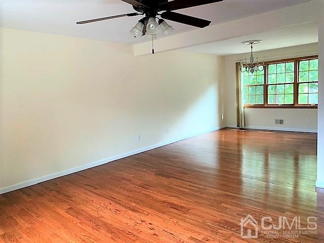 24 Hillsdale Road Edison, NJ 08820 - Photo 12 of 41 an empty room with wooden floor fan and windows