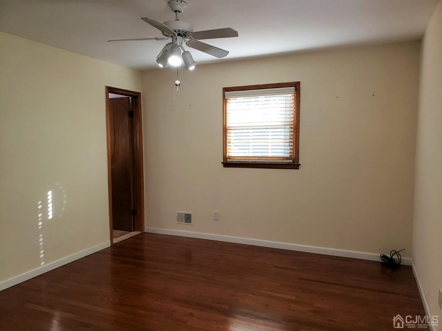24 Hillsdale Road Edison, NJ 08820 - Photo 13 of 41 a view of an empty room with wooden floor and a ceiling fan