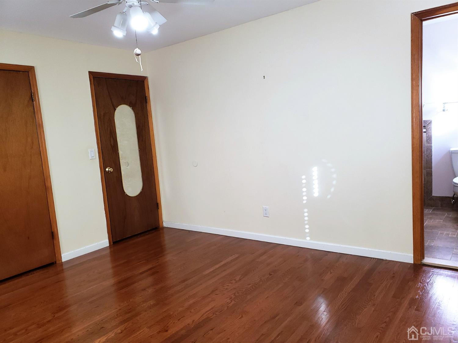 24 Hillsdale Road Edison, NJ 08820 - Photo 14 of 41 a view of an empty room with wooden floor and a window